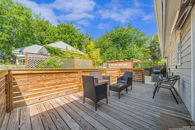 a view of a chairs and table on the wooden deck