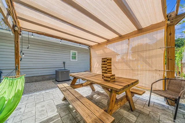 a backyard of a house with table and chairs
