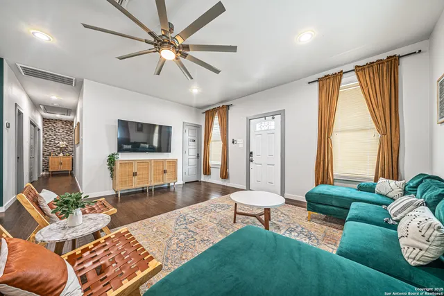 a living room with furniture and a flat screen tv