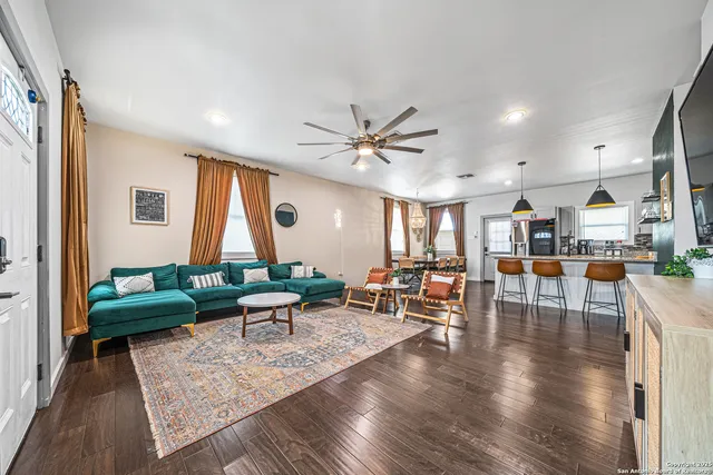 a living room with furniture and wooden floor