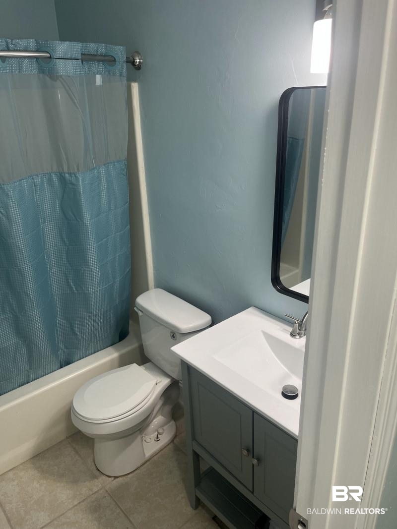 609 East Orange Avenue Foley, AL 36535 - Photo 6 of 6 Full bath with shower / bathtub combination with curtain, vanity, and tile patterned flooring