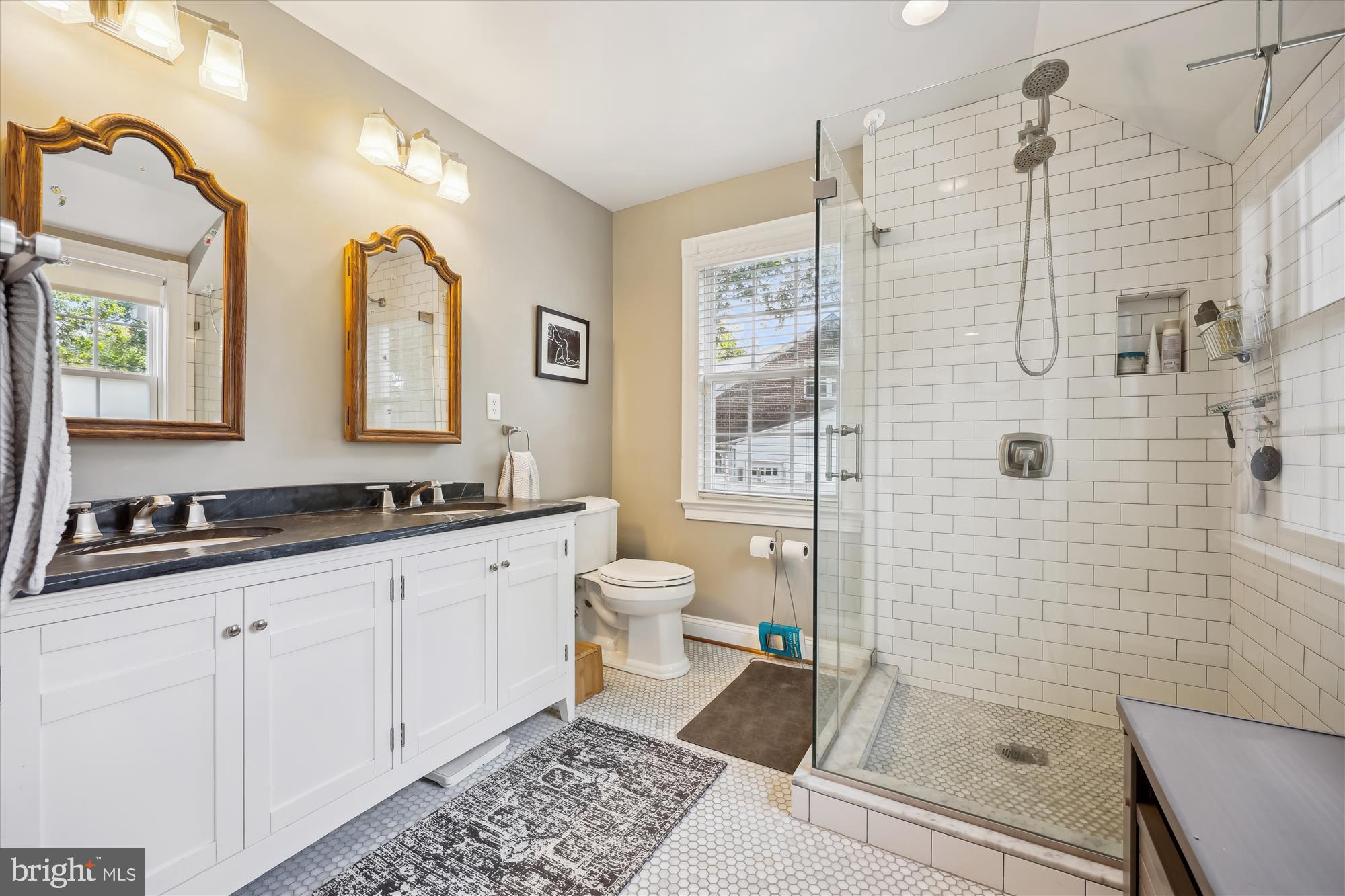 8103 Piney Branch Road Silver Spring, MD 20910 - Photo 22 of 42 a bathroom with a shower sink and mirror