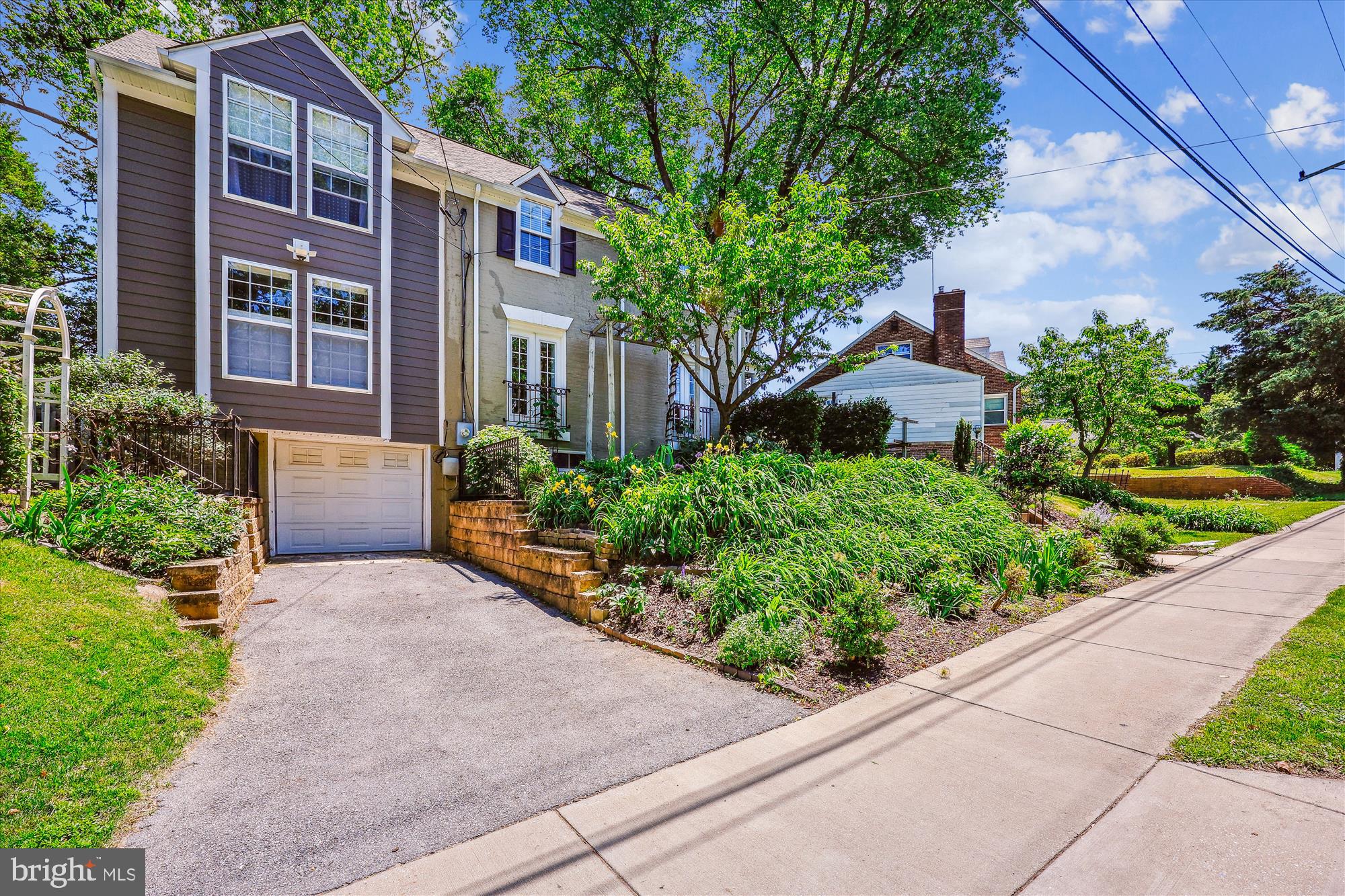 8103 Piney Branch Road Silver Spring, MD 20910 - Photo 36 of 42 a front view of a house with a yard and potted plants