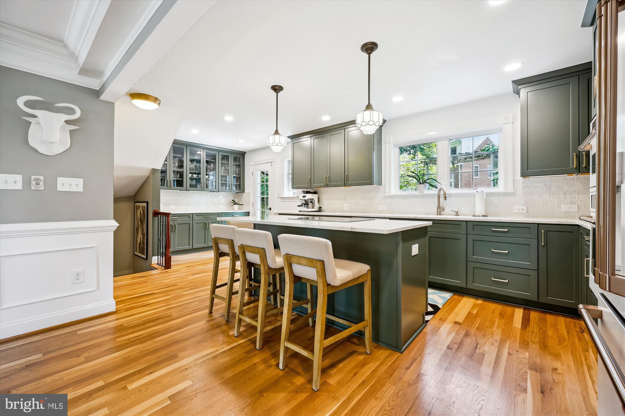 8103 Piney Branch Road Silver Spring, MD 20910 - Photo 5 of 42 a kitchen with stainless steel appliances kitchen island granite countertop a stove a sink and a wooden floors