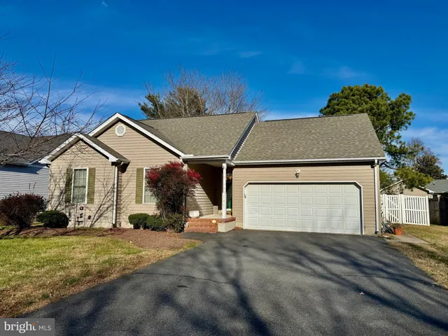 a view of a white house with a yard