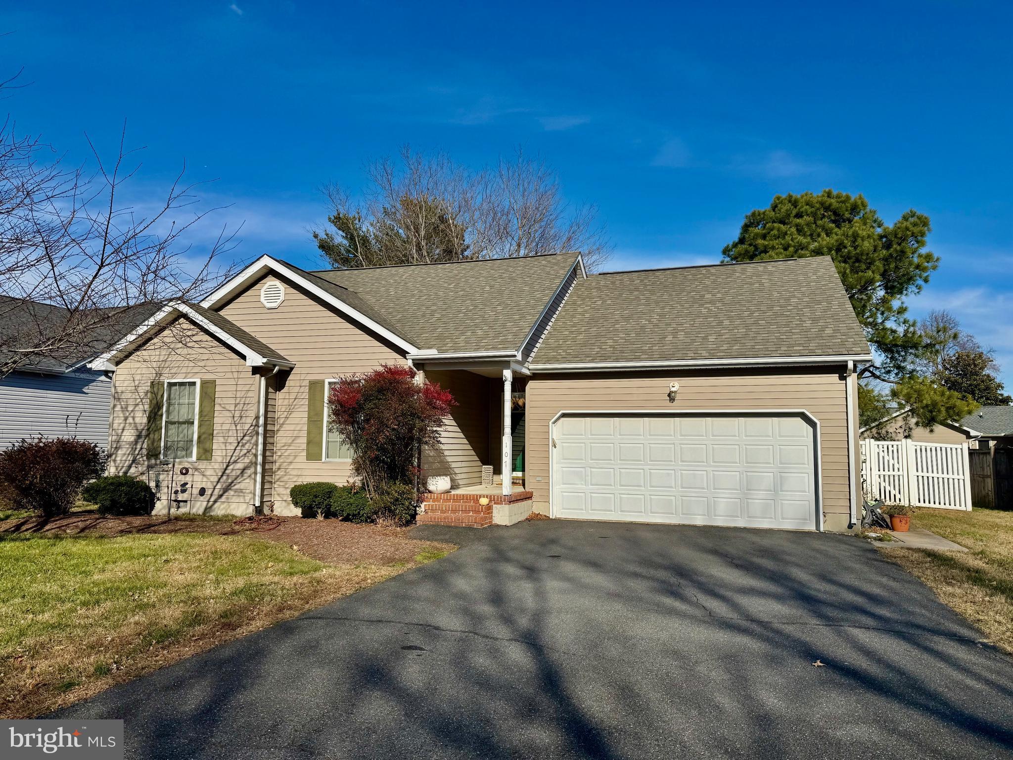 a view of a white house with a yard