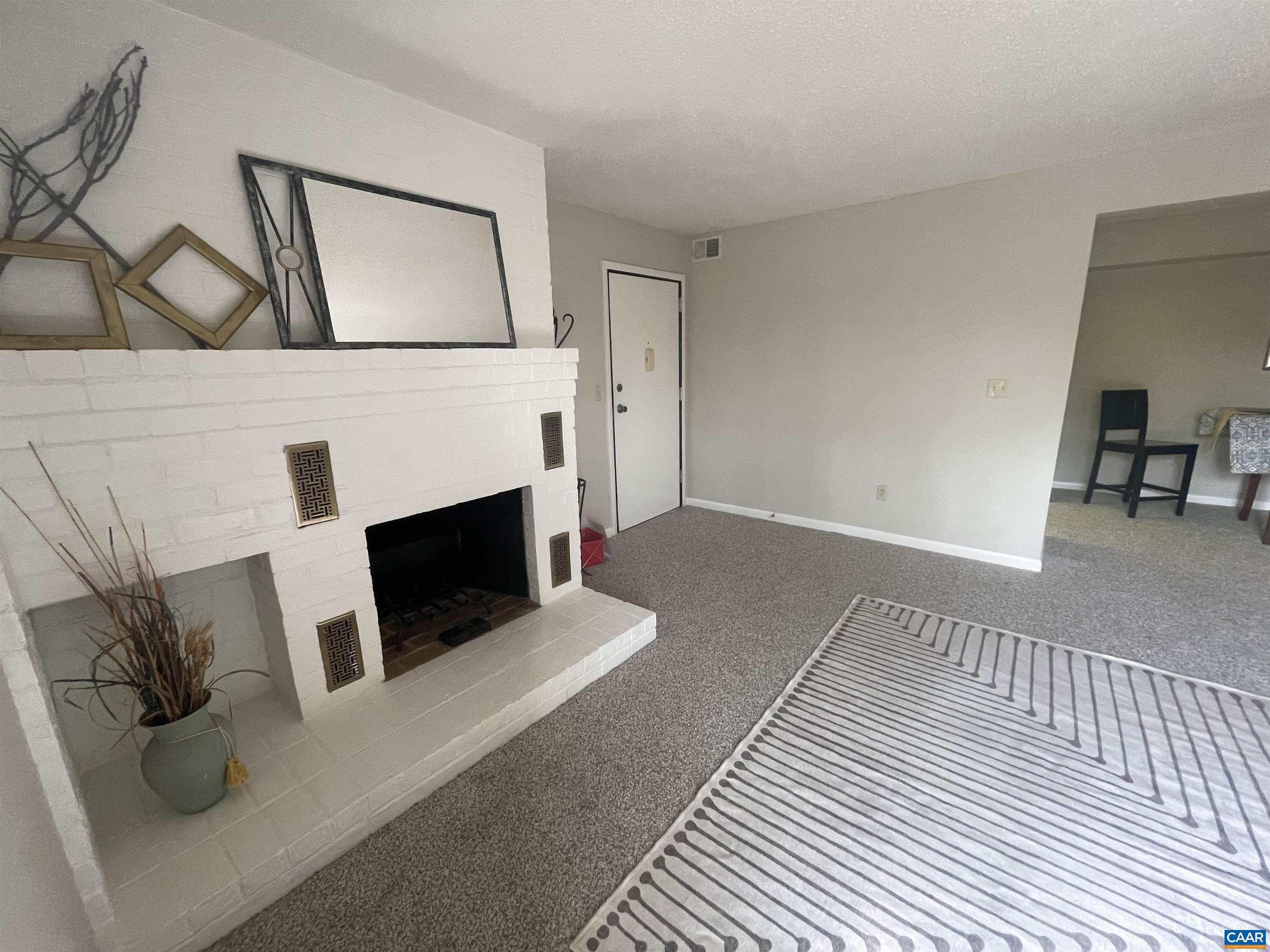 115 Turtle Creek Road, Unit 8 Charlottesville, VA 22901 - Photo 17 of 40 a living room with furniture and a fireplace