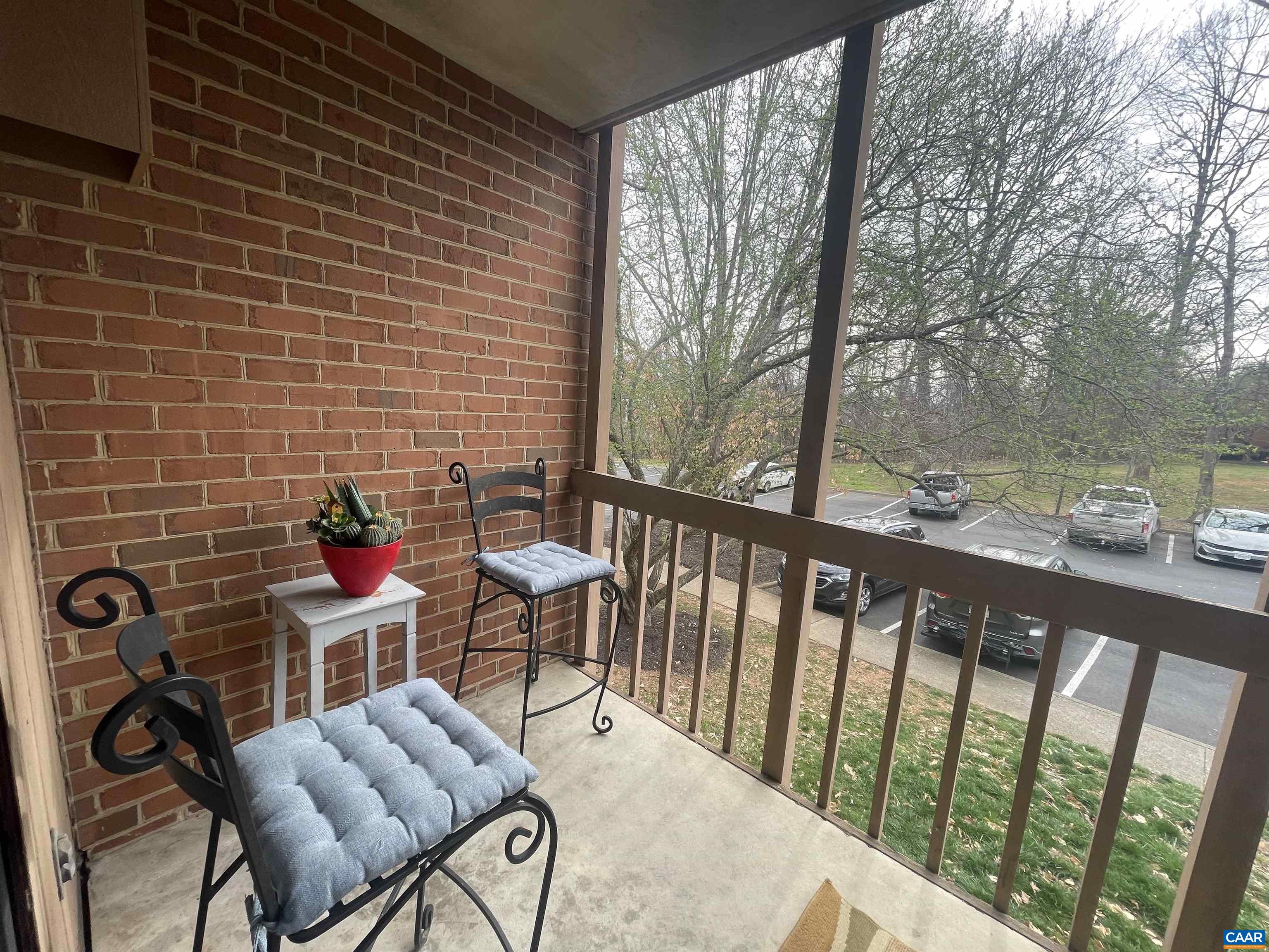 115 Turtle Creek Road, Unit 8 Charlottesville, VA 22901 - Photo 20 of 40 a view of a chair and tables in the balcony