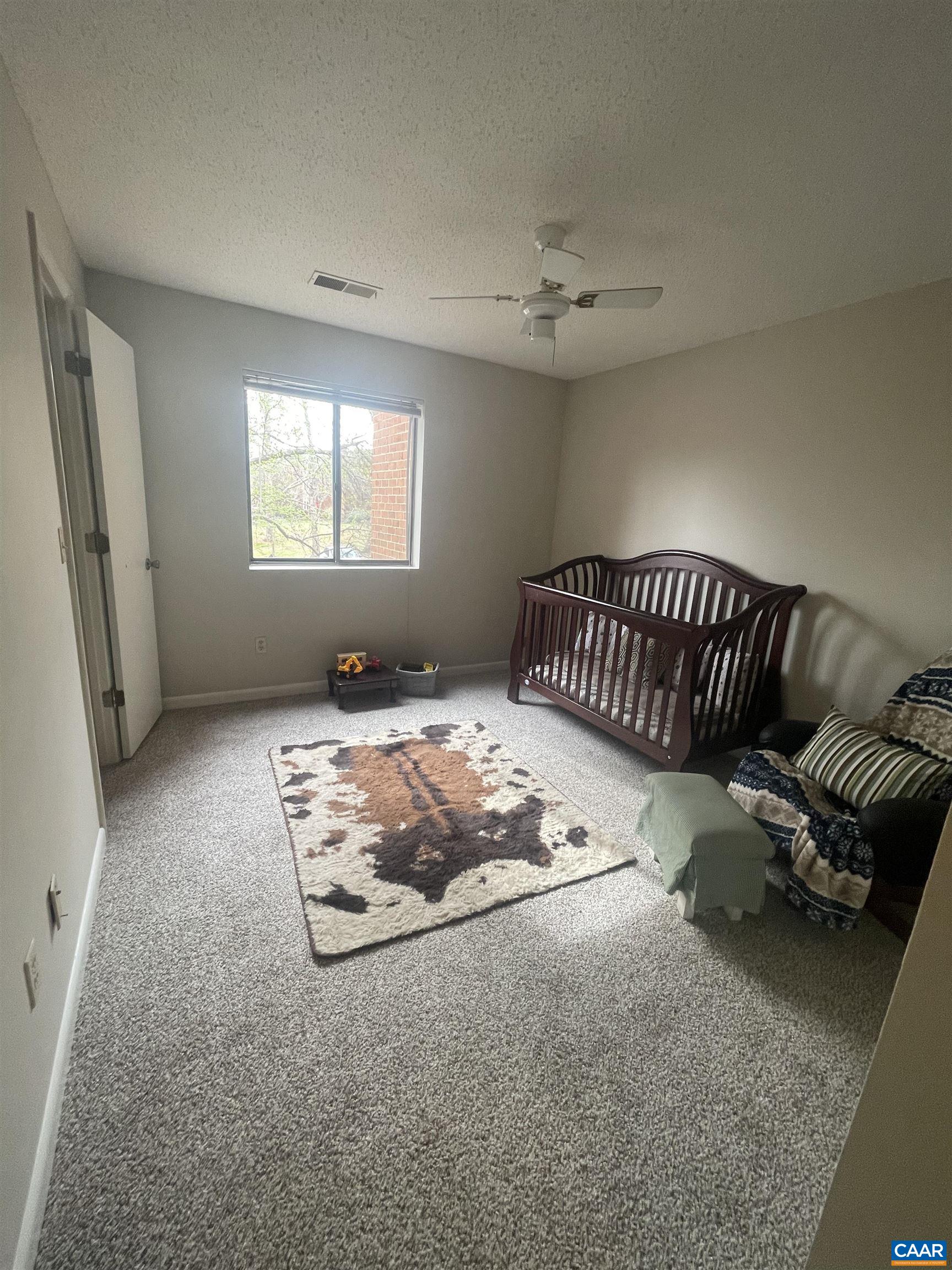 115 Turtle Creek Road, Unit 8 Charlottesville, VA 22901 - Photo 29 of 40 a bedroom with bed couch and window