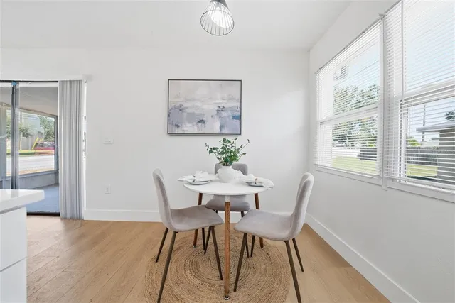 a view of a dining room with furniture window and wooden floor