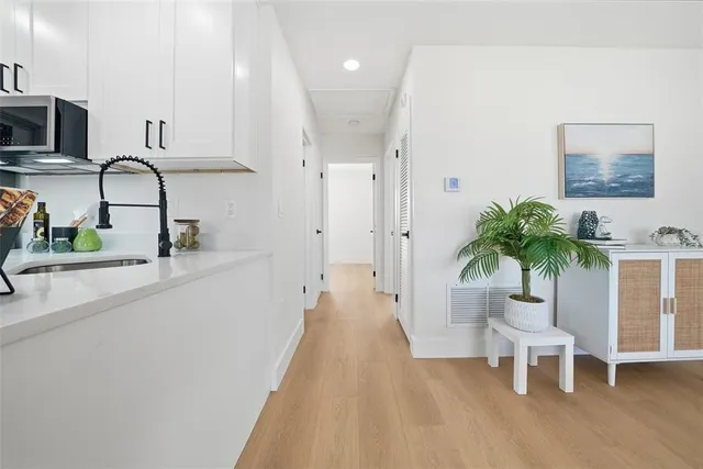 a view of a kitchen with furniture and a potted plant