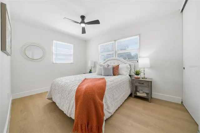 a bedroom with a bed and a chandelier