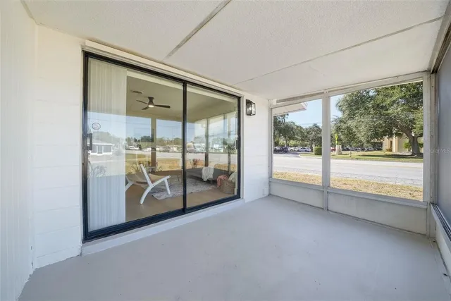 an empty room with large glass windows