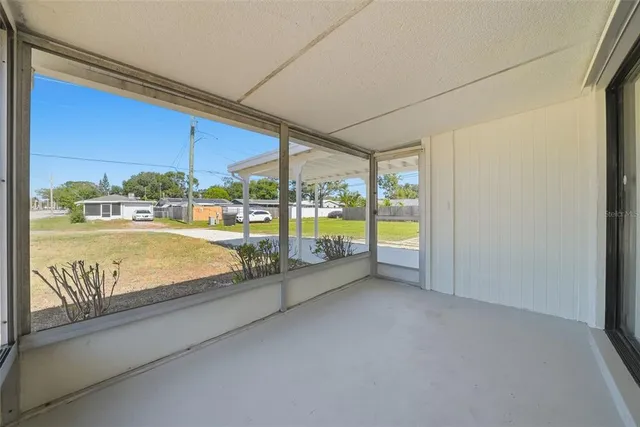 a view of an empty room with a floor to ceiling window