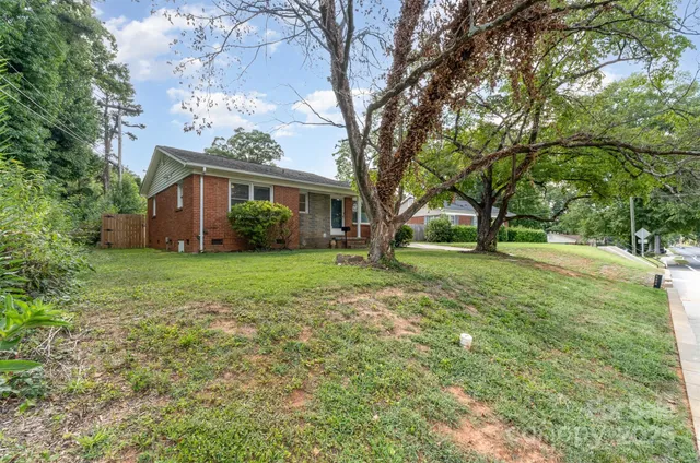 a view of house with yard