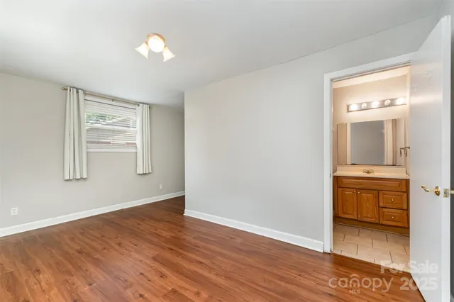 a view of room with window and wooden floor