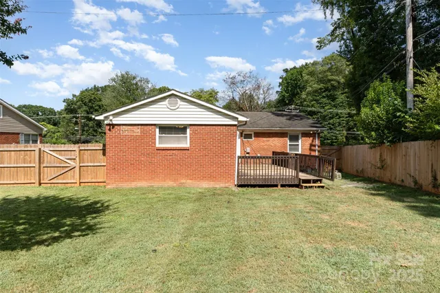 a view of a house with a yard and sitting area