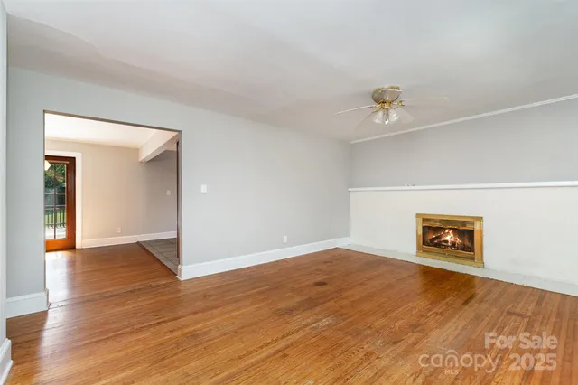 an empty room with a empty space and wooden floor