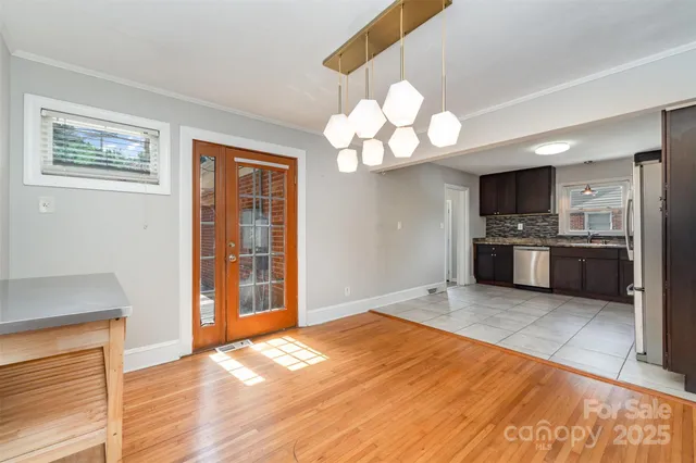 a view of a kitchen with a stove wooden cabinets and wooden floor
