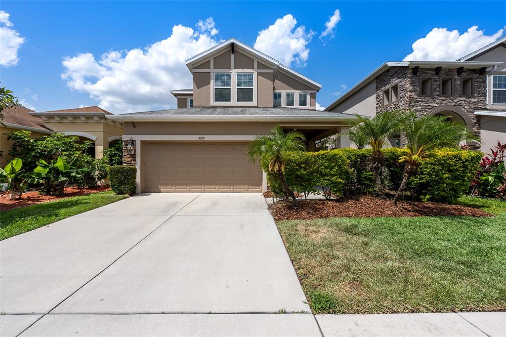 7699 Windchase Way Wesley Chapel, FL 33545 - Photo 1 of 1 a front view of a house with a yard