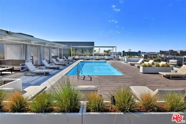 a view of a swimming pool with outdoor seating