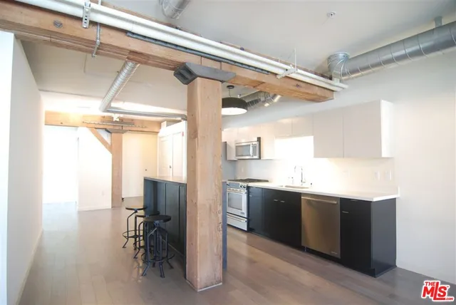 a kitchen with a sink appliances and cabinets