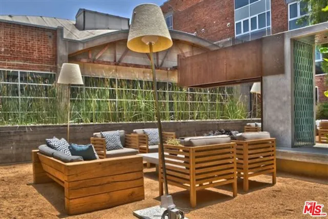 a view of a patio with dining table and chairs with wooden floor