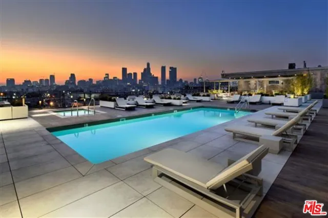 a view of a swimming pool and lounge chairs