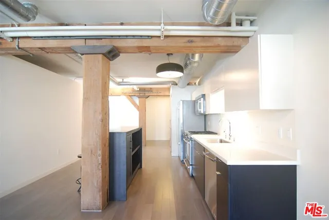 a kitchen with a sink and refrigerator