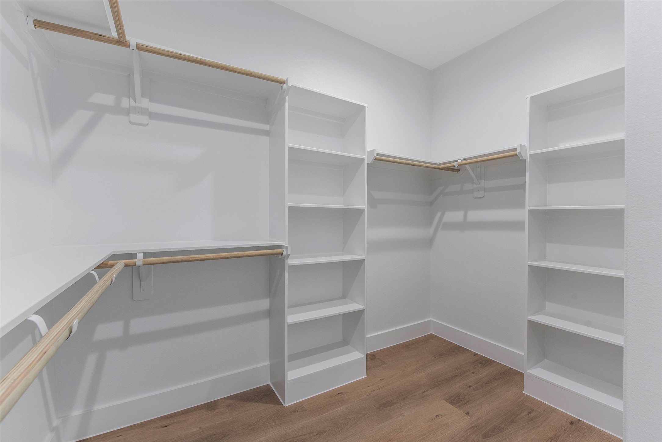 9311 Jutland Road Houston, TX 77033 - Photo 13 of 28 An ample walk-in closet featuring built-in shelving and generous hanging space, thoughtfully designed for organized, effortless storage.