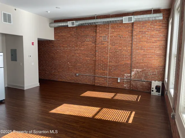 a view of a hall with wooden floor