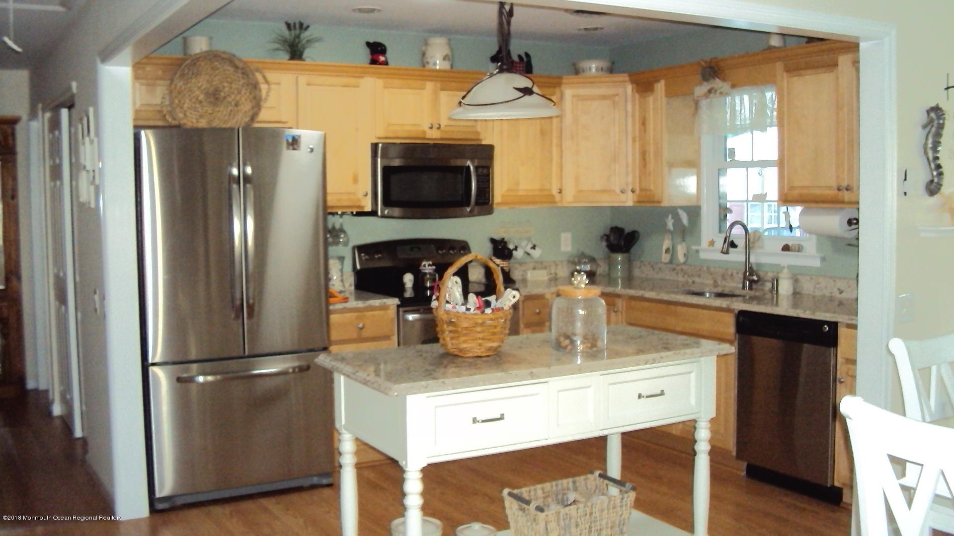 a kitchen with stainless steel appliances granite countertop a refrigerator a stove and a sink