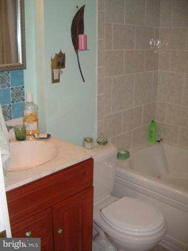 2002 Plyers Mill Road Silver Spring, MD 20902 - Photo 13 of 29 a bathroom with a sink a toilet and bathtub