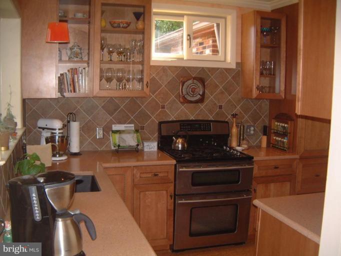 2002 Plyers Mill Road Silver Spring, MD 20902 - Photo 3 of 29 a kitchen with a stove and a microwave
