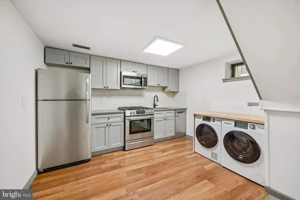 a kitchen with a refrigerator sink and stove top oven