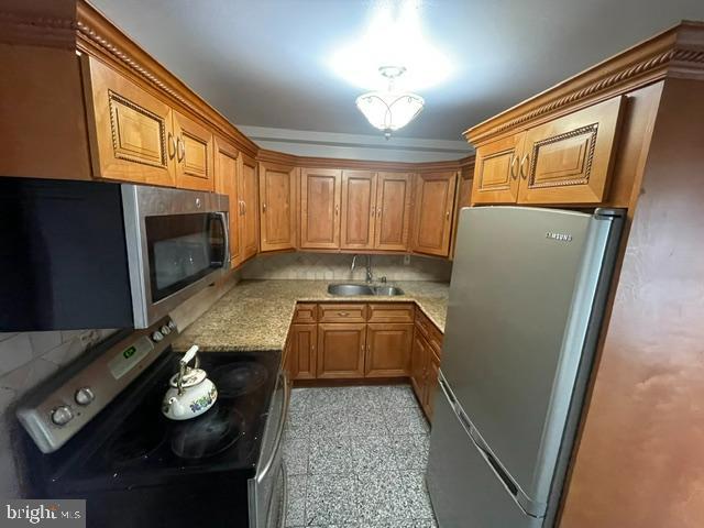 10 Middle Road Levittown, PA 19056 - Photo 21 of 25 a kitchen with granite countertop a refrigerator and a stove
