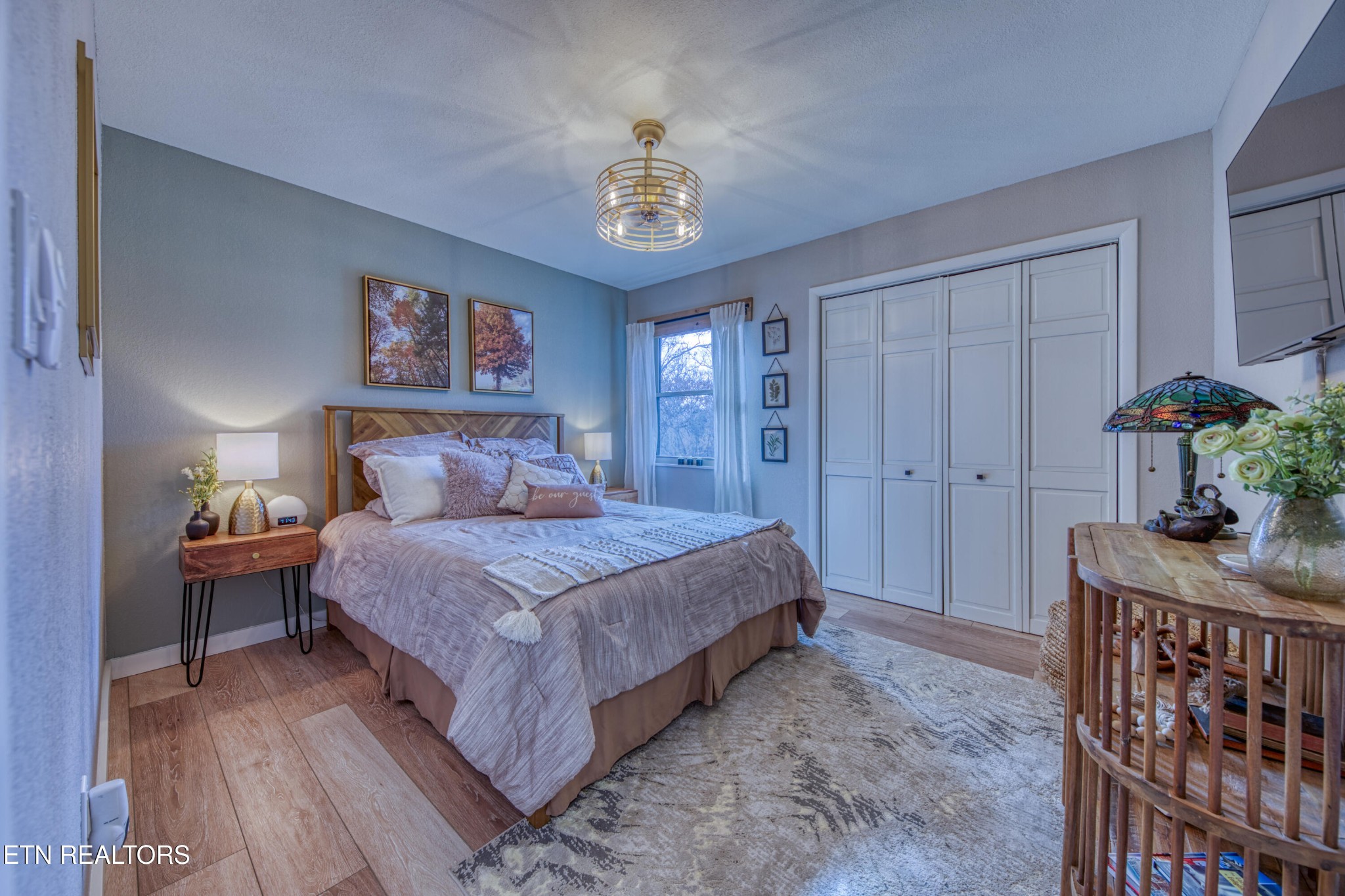 333 Enchanted Forest Way Sevierville, TN 37876 - Photo 13 of 42 a bedroom with a bed and a chandelier
