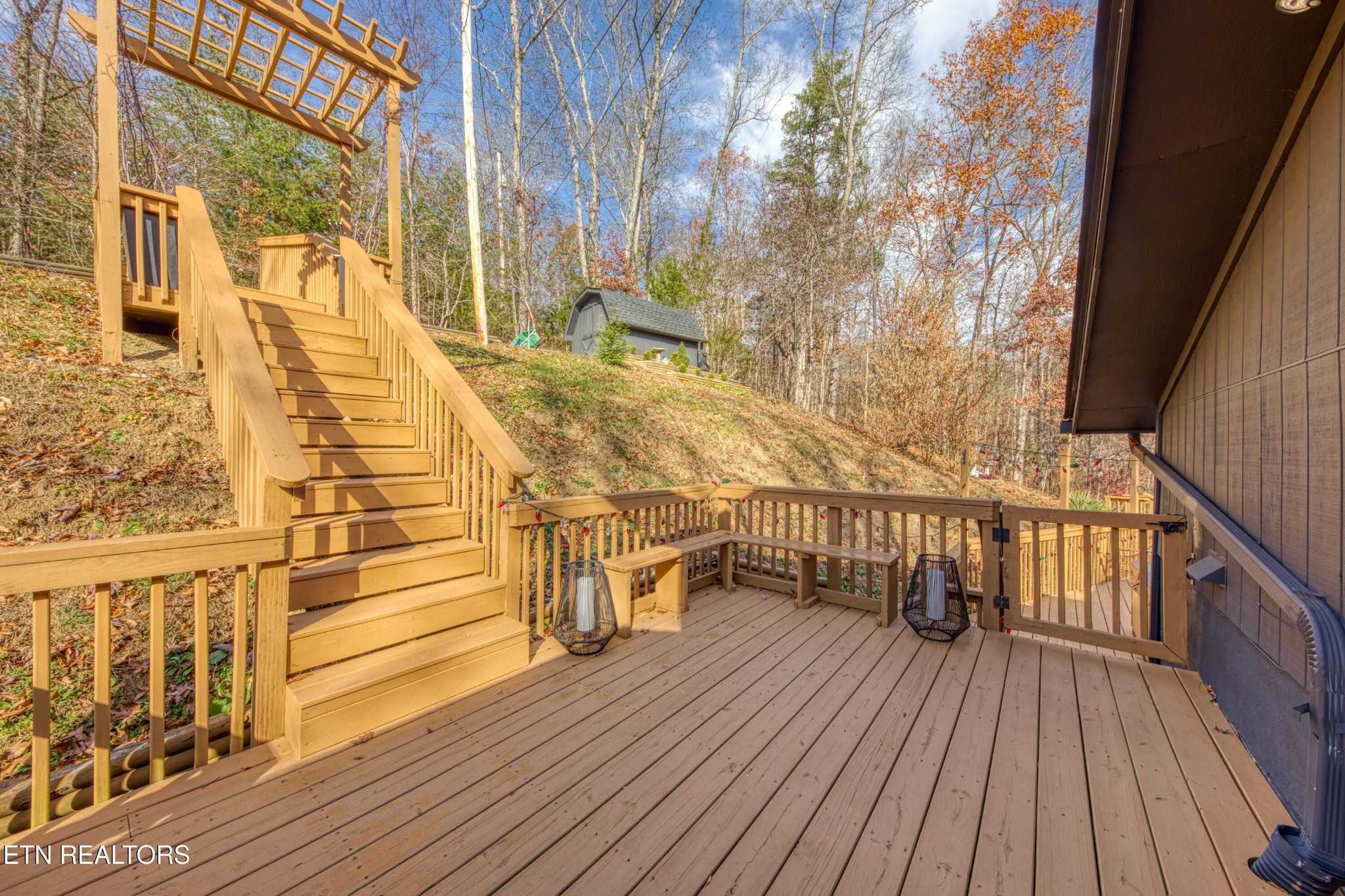 333 Enchanted Forest Way Sevierville, TN 37876 - Photo 30 of 42 a view of a balcony with wooden floor and iron stairs
