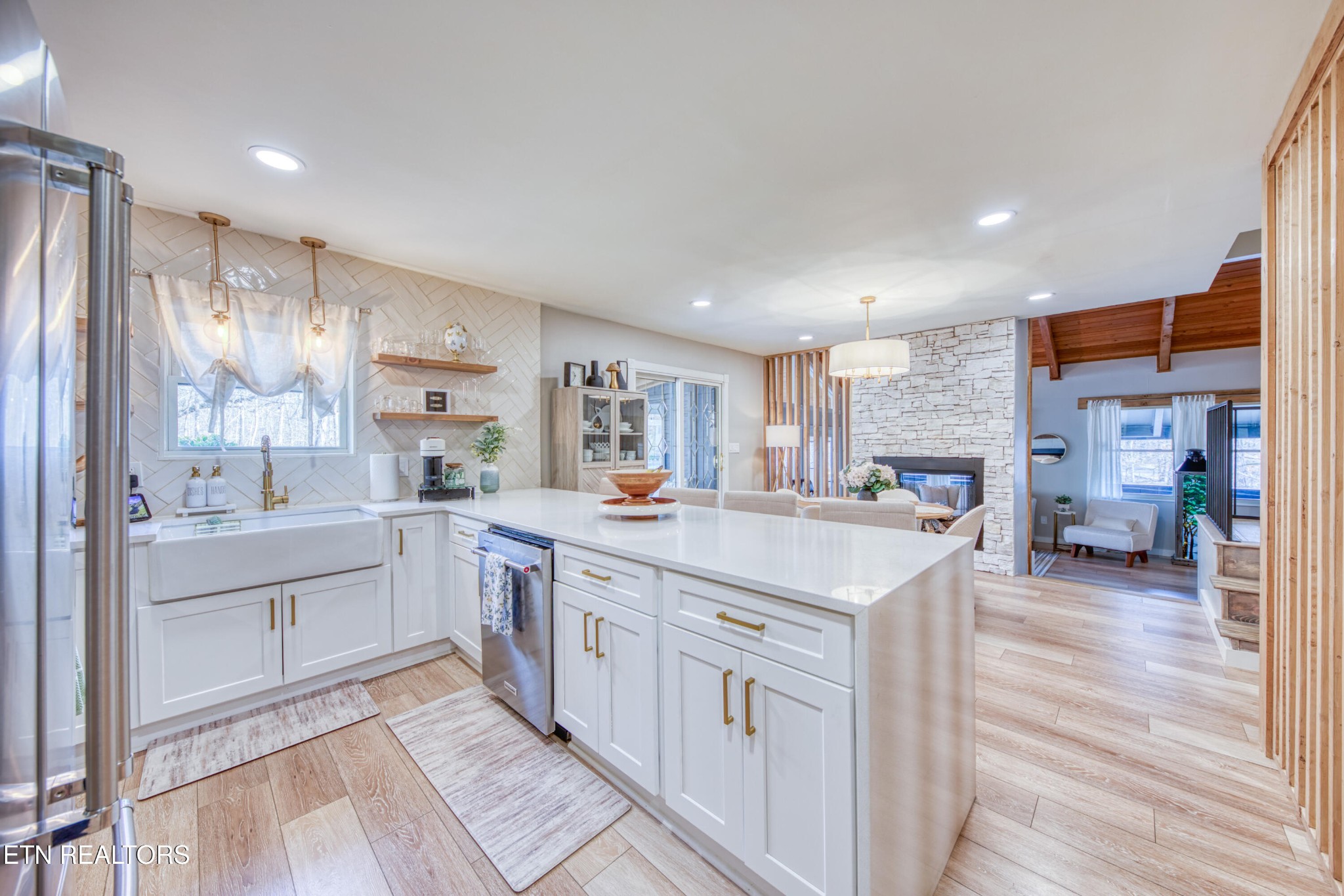 333 Enchanted Forest Way Sevierville, TN 37876 - Photo 6 of 42 a open kitchen with stainless steel appliances granite countertop a refrigerator oven a sink dishwasher and white cabinets with wooden floor
