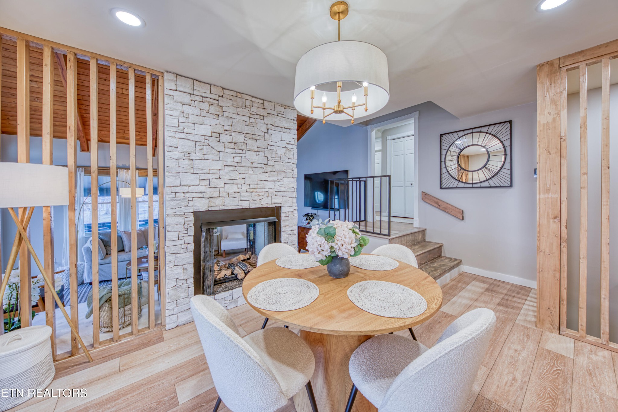 333 Enchanted Forest Way Sevierville, TN 37876 - Photo 8 of 42 a view of a dining room with furniture wooden floor and a chandelier