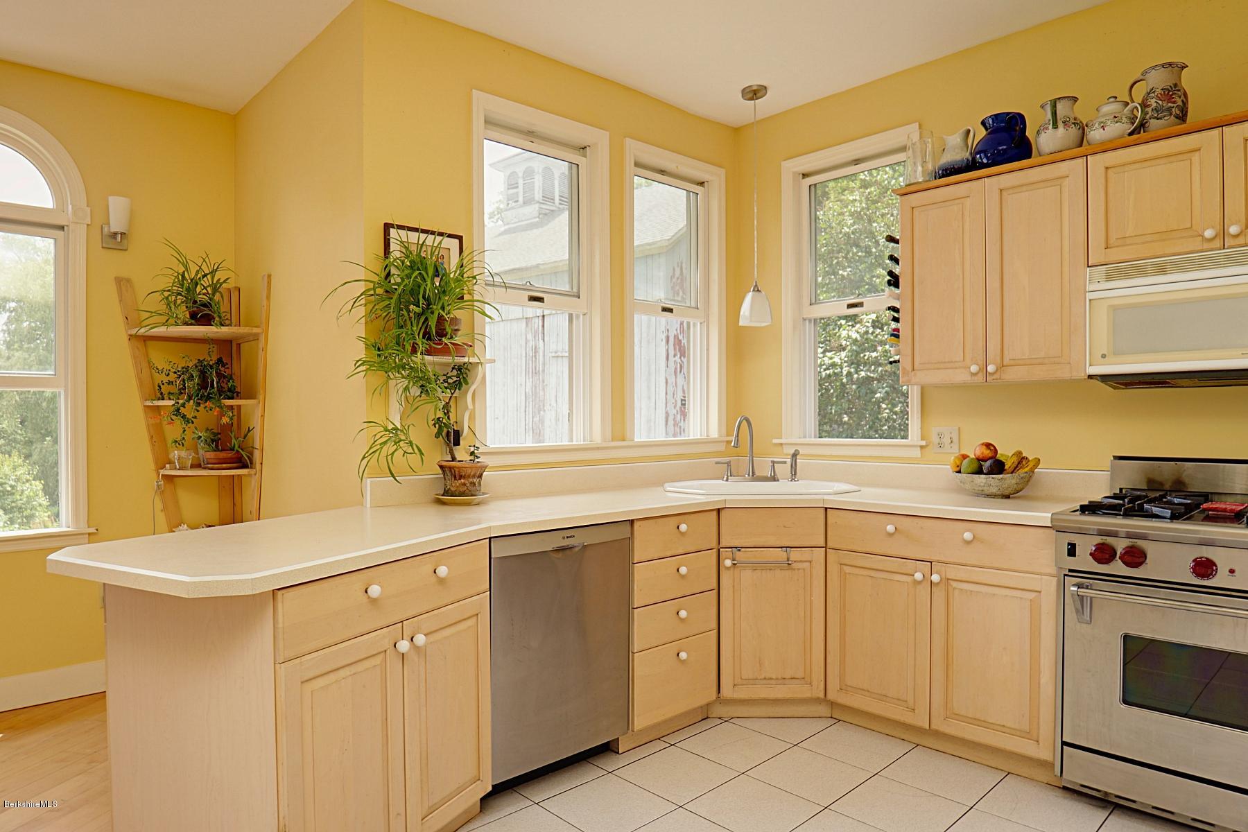 200 Main Road Monterey, MA 01245 - Photo 15 of 30 a kitchen with white cabinets and white appliances