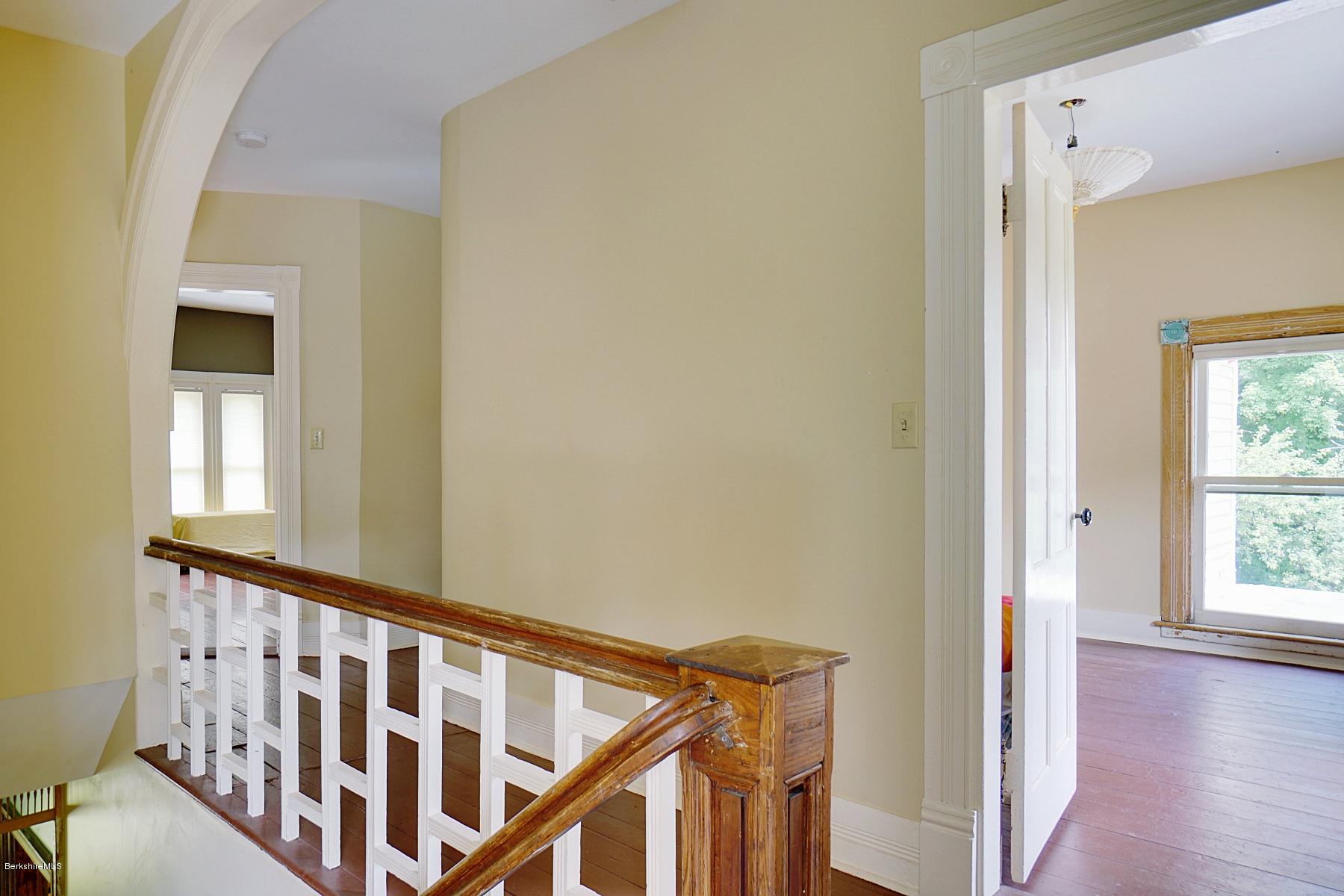 200 Main Road Monterey, MA 01245 - Photo 18 of 30 a view of a hallway with wooden floor and staircase