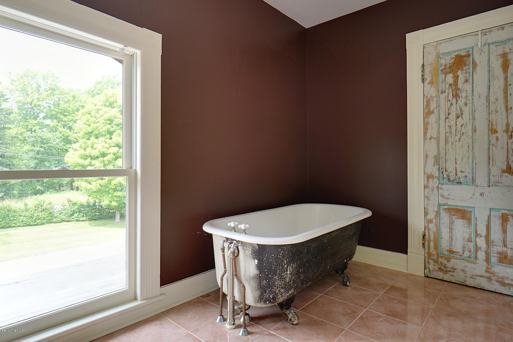 200 Main Road Monterey, MA 01245 - Photo 22 of 30 a room with a door and a window