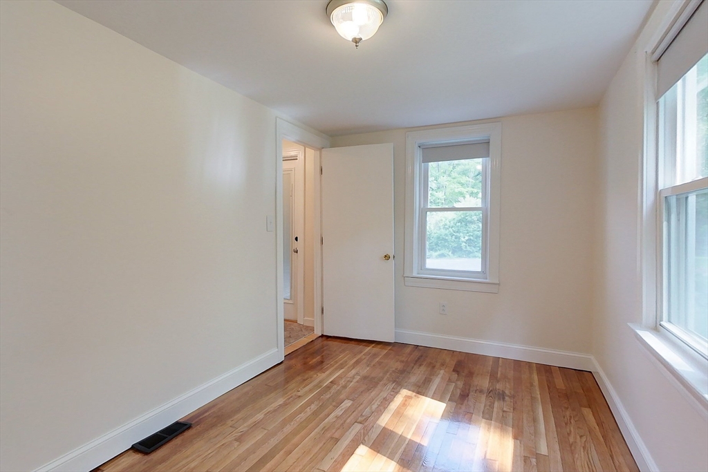 92 Squannacook Road Shirley, MA 01464 - Photo 14 of 38 a view of an empty room with wooden floor and a window