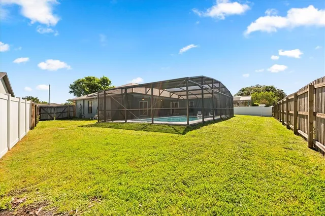 a view of a swimming pool with an outdoor space and seating area