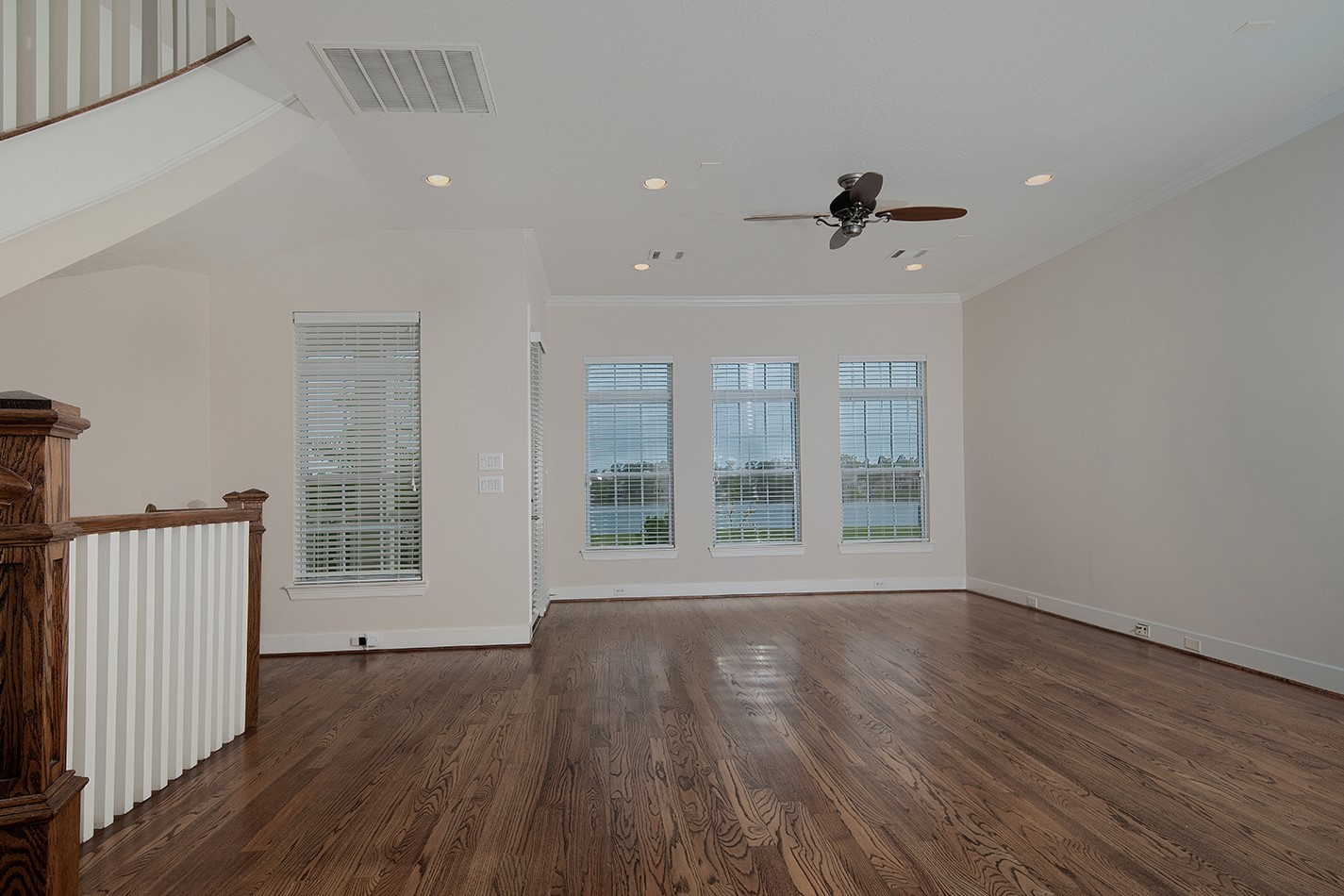190 West Breezy Way Spring, TX 77380 - Photo 10 of 33 Spacious living area with hardwood floors and large windows offering plenty of natural light. Perfect for comfortable living and entertaining.