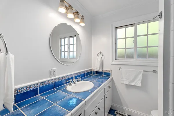 a bathroom with a double vanity sink and a mirror
