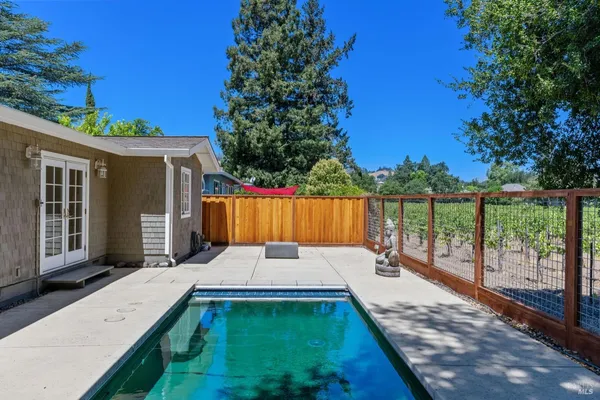 a view of small pool with a patio