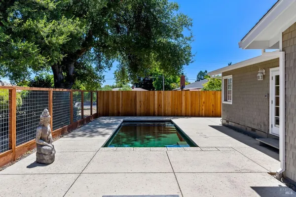 a view of with backyard with wooden fence