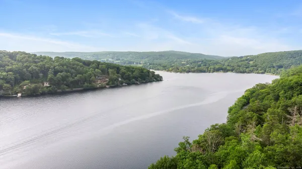 an aerial view of a house with a yard and lake view